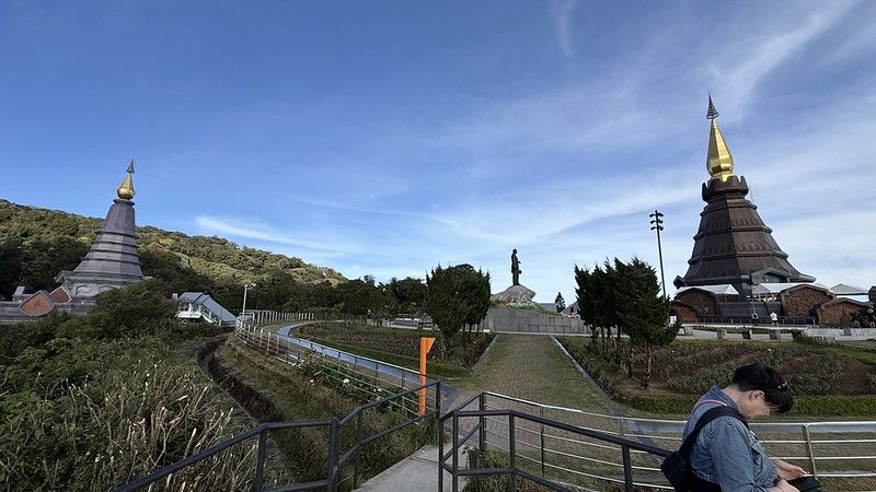 A panorama of the two pagodas with the Queen's pagoda on the left and the King's pagoda on the right, in the middle is a statue of the king.