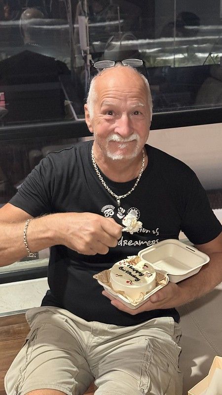 Tony delightedly eating a birthday cake