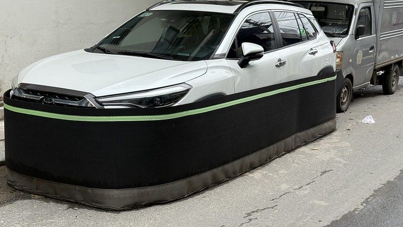 A white car with a black skirt surrounding it